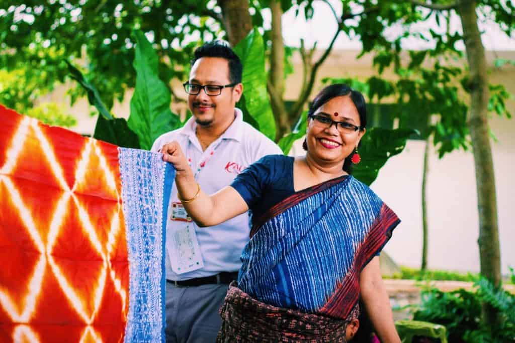 Rina Akter, Master Dyer of Aranya showing off the freshly dyed piece of scarf